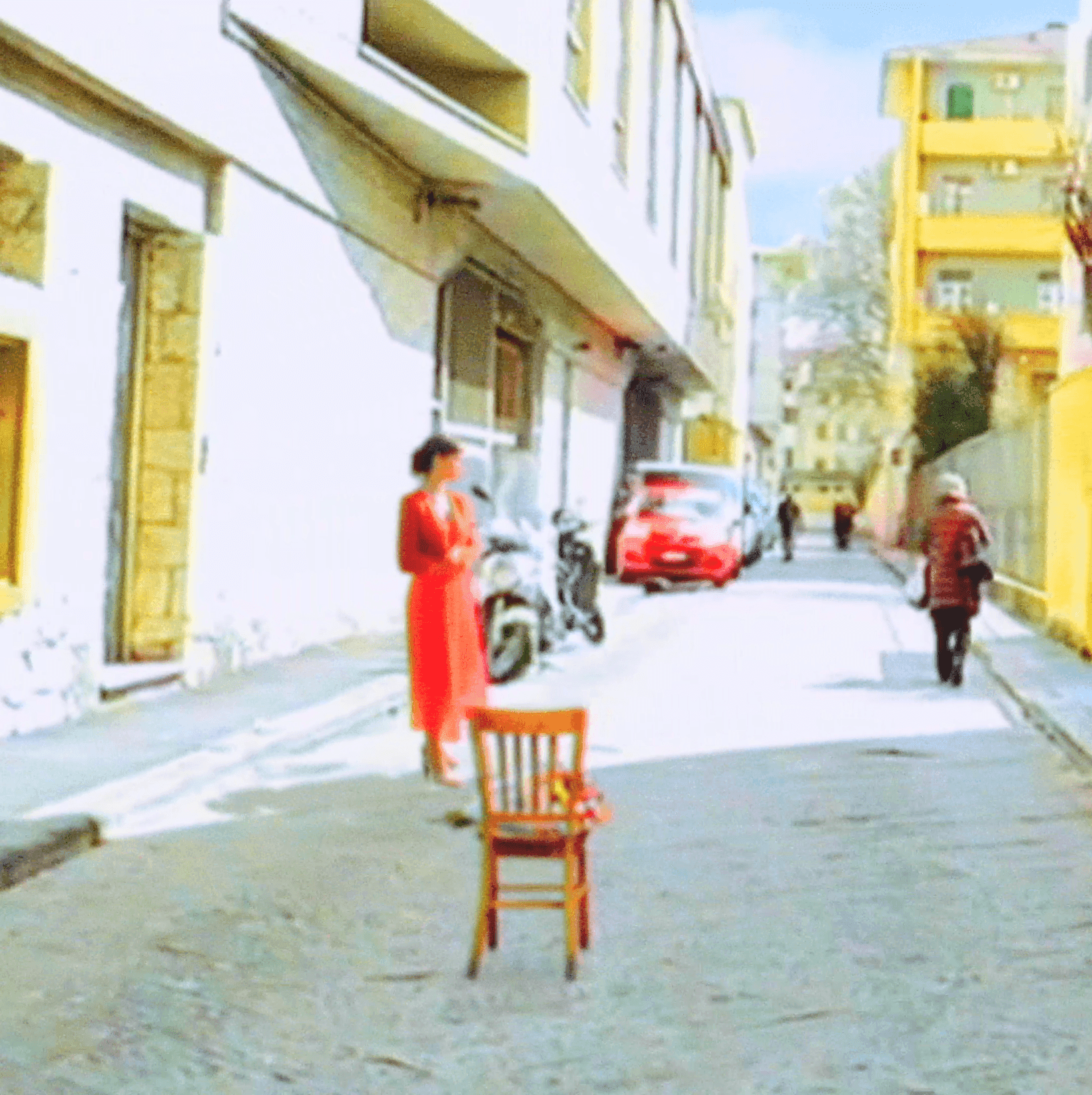 Woman in red by wooden chair